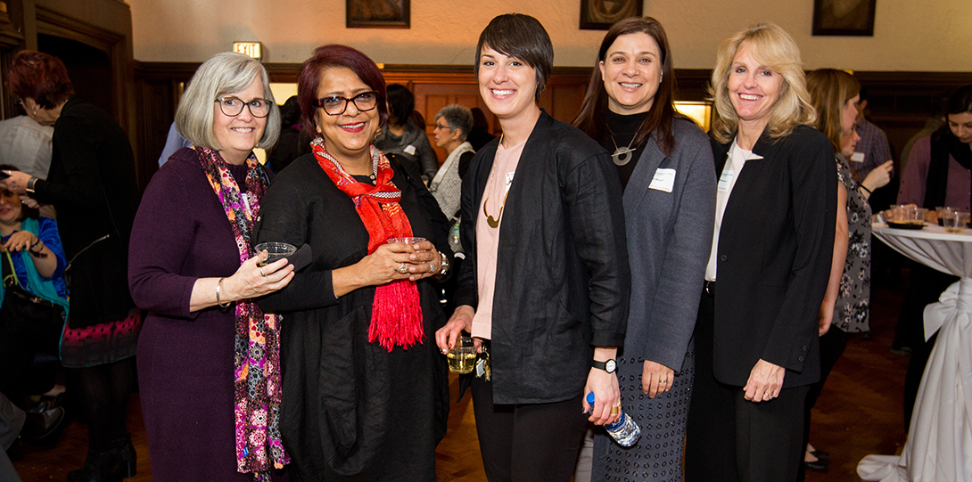 A group of 5 women smiling at the camera