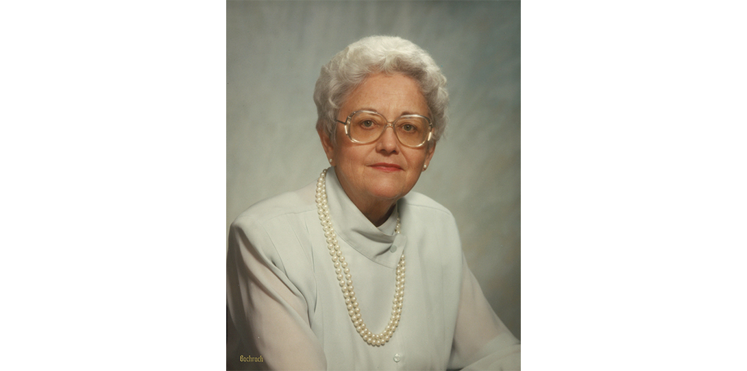 A woman seated smiling at the camera