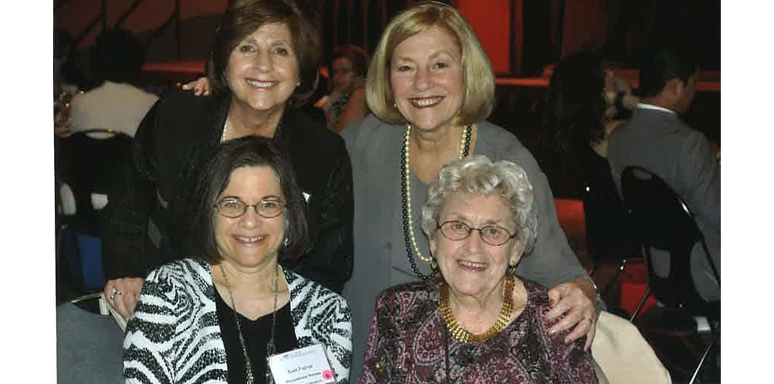 A group o four woman smiling at the camera