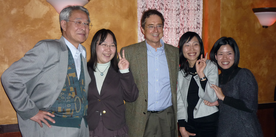 A group of 5 people smiling at the camera.