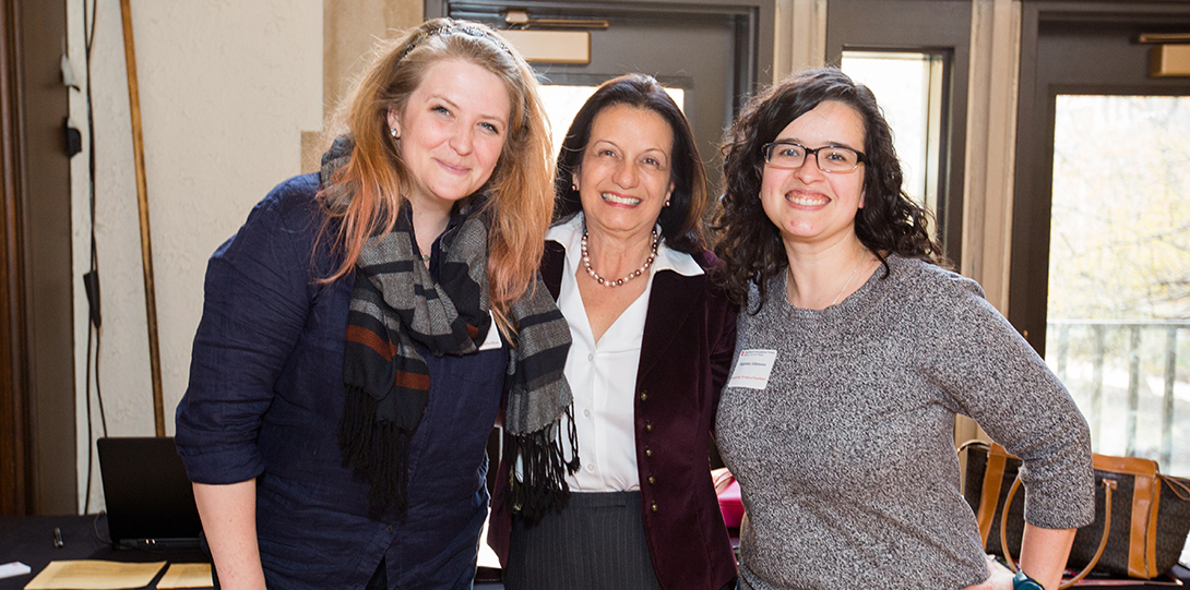 Three women standing and smiling at the camera